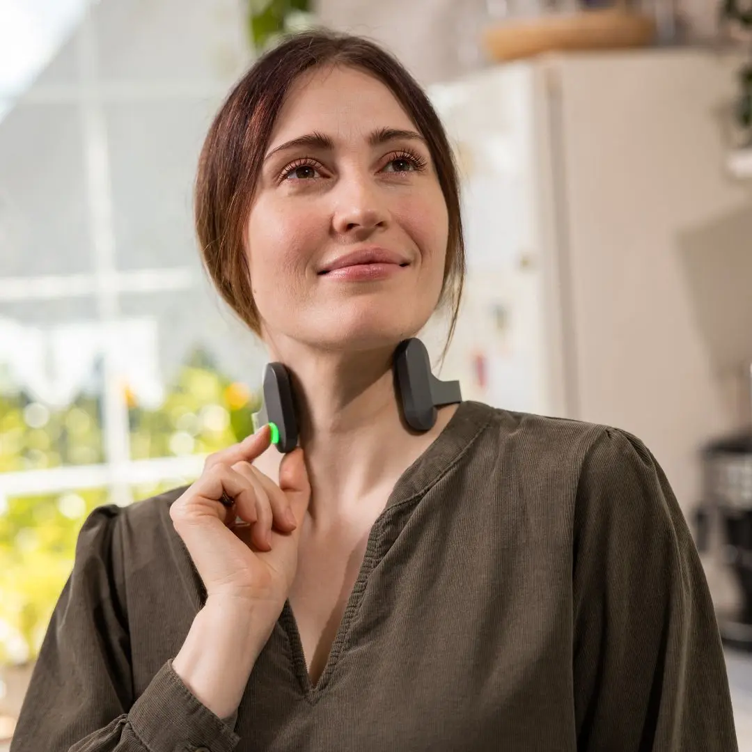 Woman wearing Pulsetto device looking relaxed
